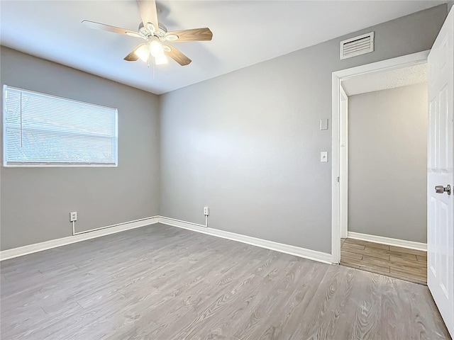 spare room featuring light wood-type flooring and ceiling fan