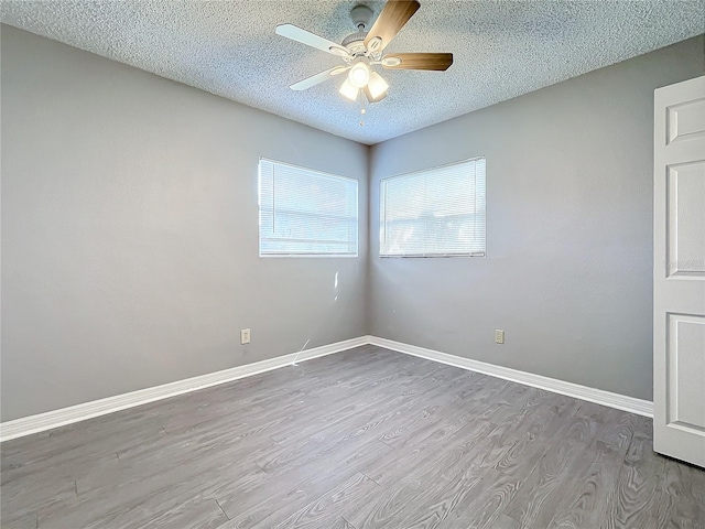 spare room featuring ceiling fan, light hardwood / wood-style floors, and a textured ceiling