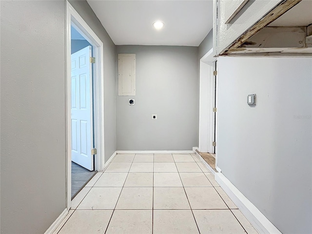 corridor with light tile patterned floors and electric panel