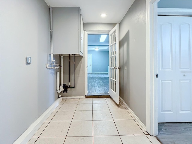 hall with light tile patterned floors