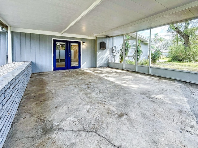 unfurnished sunroom featuring a wealth of natural light and french doors