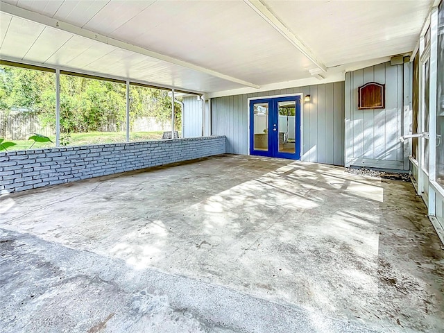 unfurnished sunroom with french doors