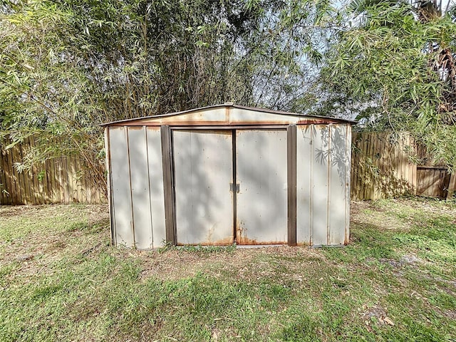 view of outdoor structure featuring a lawn