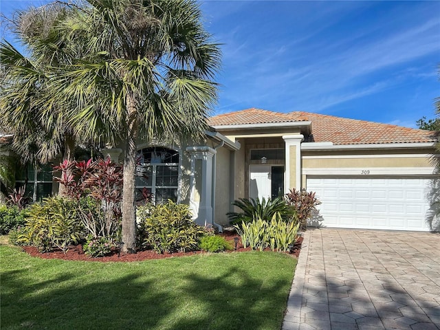 view of front of property featuring a garage and a front yard