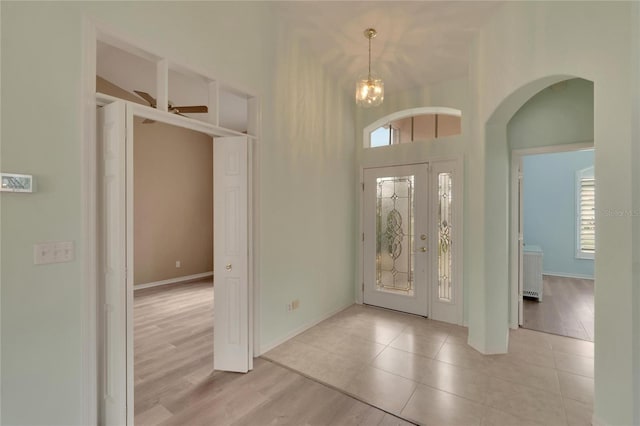 foyer entrance with ceiling fan and light hardwood / wood-style flooring