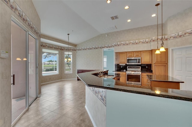 kitchen with appliances with stainless steel finishes, vaulted ceiling, light tile patterned floors, decorative light fixtures, and a notable chandelier