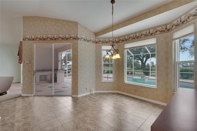 unfurnished dining area featuring tile patterned flooring, plenty of natural light, vaulted ceiling, and a chandelier