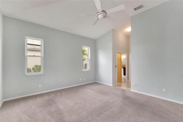 carpeted empty room featuring ceiling fan and lofted ceiling