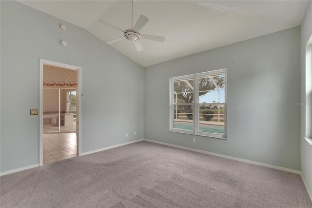 carpeted spare room with ceiling fan and lofted ceiling