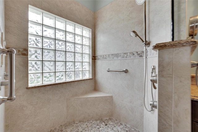 bathroom with a tile shower