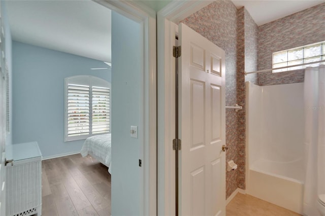 bathroom featuring a wealth of natural light, toilet, and hardwood / wood-style flooring