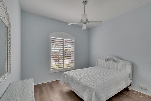 bedroom with ceiling fan and dark wood-type flooring