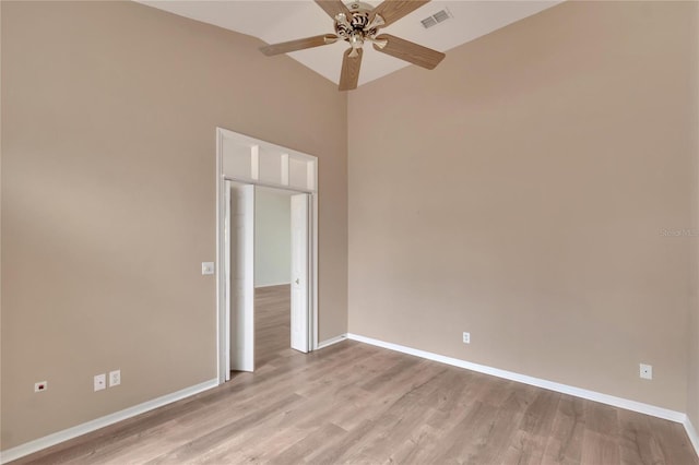 empty room with ceiling fan and light hardwood / wood-style flooring