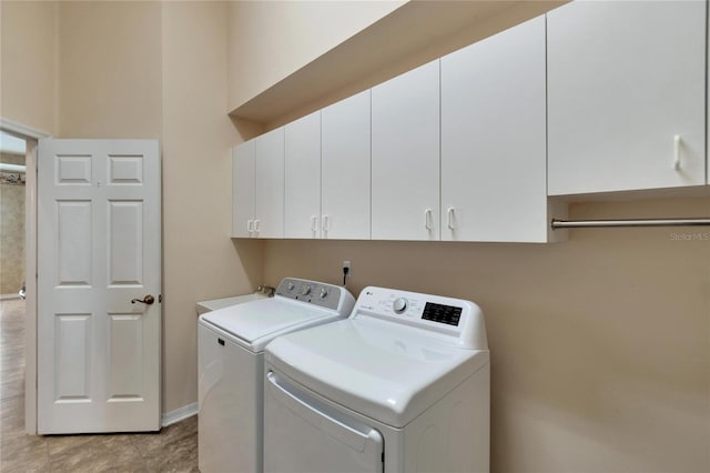 laundry area with cabinets, independent washer and dryer, sink, and light tile patterned flooring