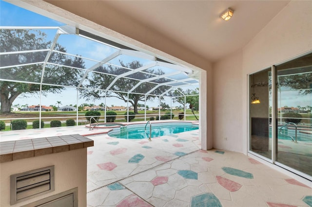 view of pool with an in ground hot tub, a patio, and glass enclosure