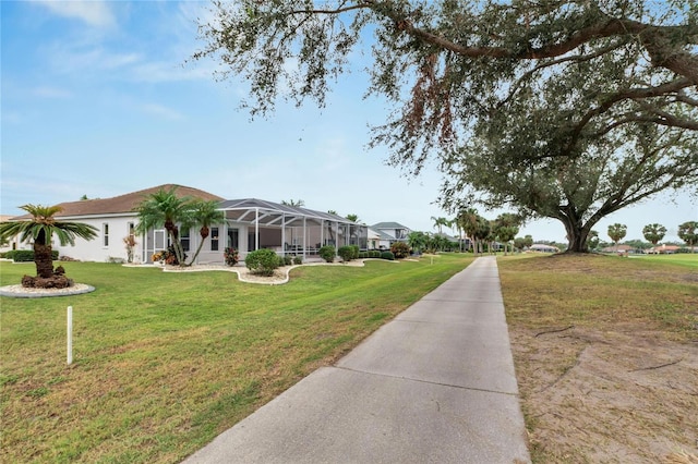 exterior space featuring a front yard and glass enclosure