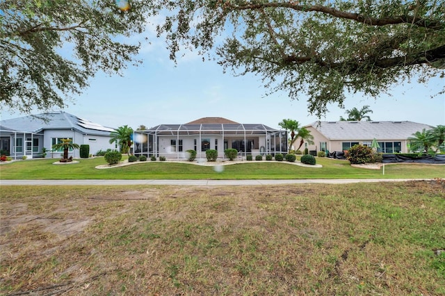 ranch-style home featuring glass enclosure and a front yard