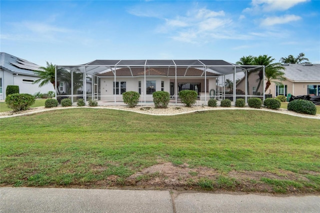 view of front facade featuring a front lawn and a lanai