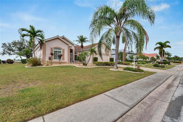 mediterranean / spanish house featuring a front lawn