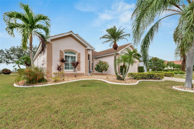 mediterranean / spanish-style house with a garage and a front lawn