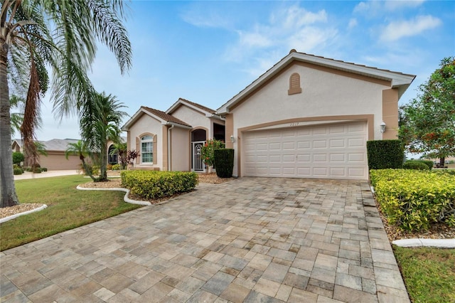 ranch-style home with a front yard and a garage