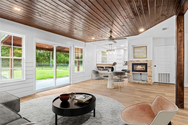 living room with ceiling fan, wooden ceiling, and light hardwood / wood-style flooring