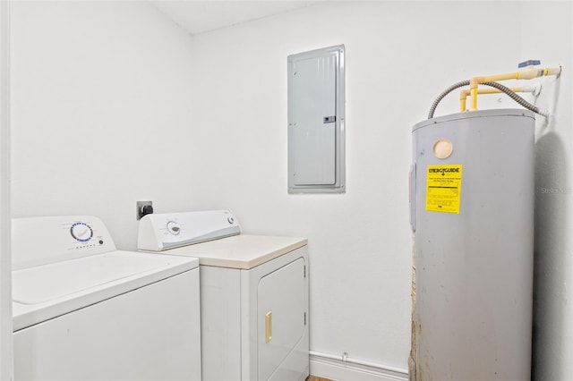 washroom featuring electric water heater, separate washer and dryer, and electric panel