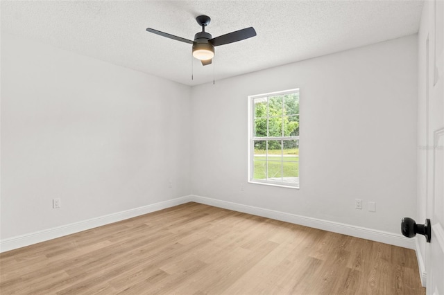 spare room with ceiling fan, light hardwood / wood-style floors, and a textured ceiling