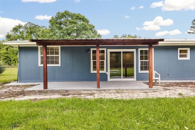 rear view of property with a patio area and a yard