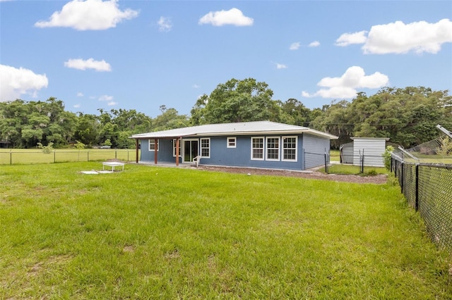 rear view of property with a lawn