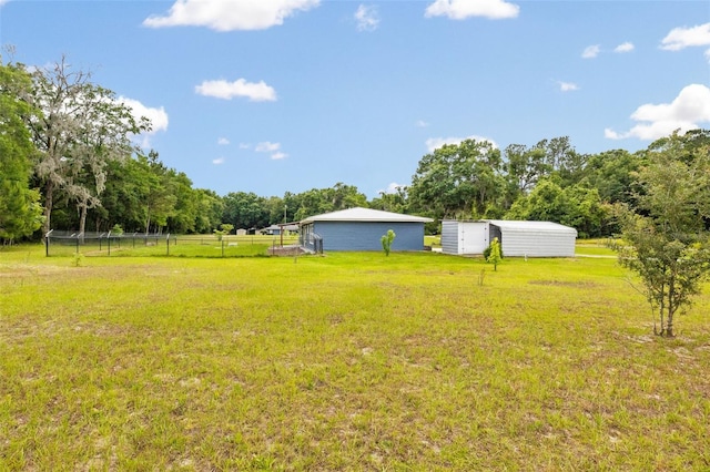 view of yard featuring an outbuilding and a rural view