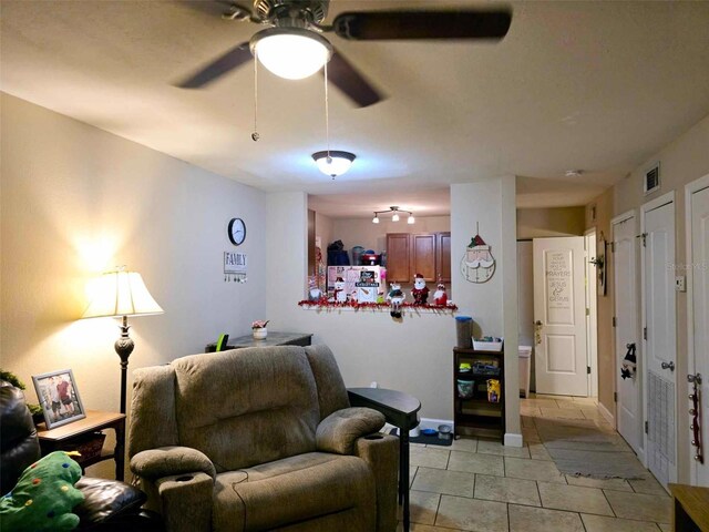 2302 Maki Rd Unit 5, Plant City, FL 33563 - living area with a ceiling fan, light tile patterned floors, and baseboards