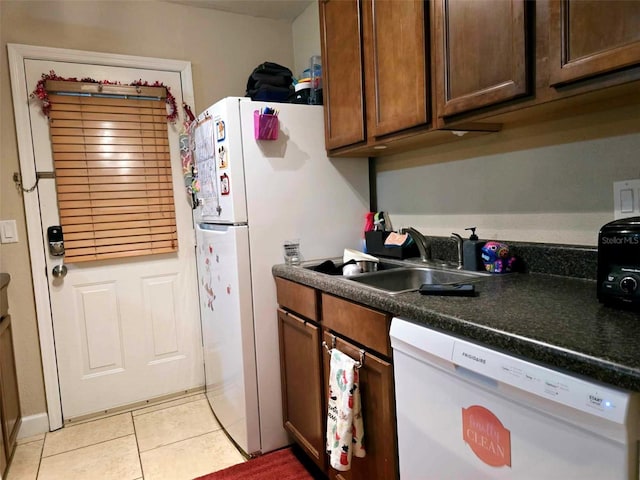 2302 Maki Rd Unit 5, Plant City, FL 33563 - kitchen featuring white dishwasher, a sink, light tile patterned floors, and dark countertops