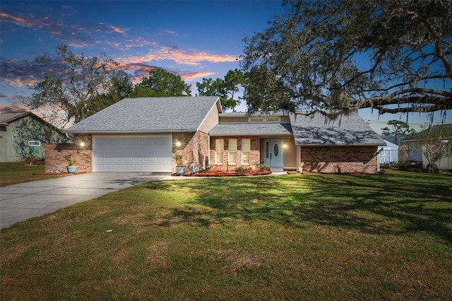 view of front of house with a yard and a garage