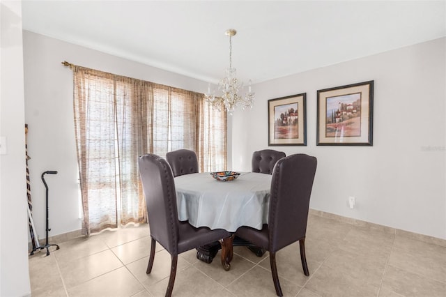 tiled dining space featuring a chandelier