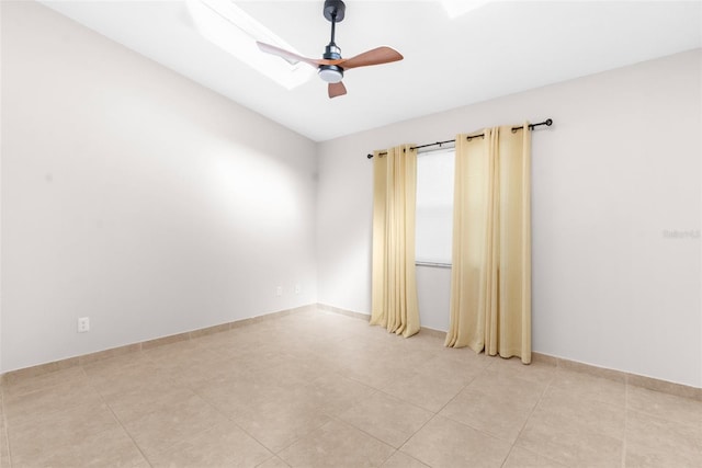 tiled spare room featuring ceiling fan