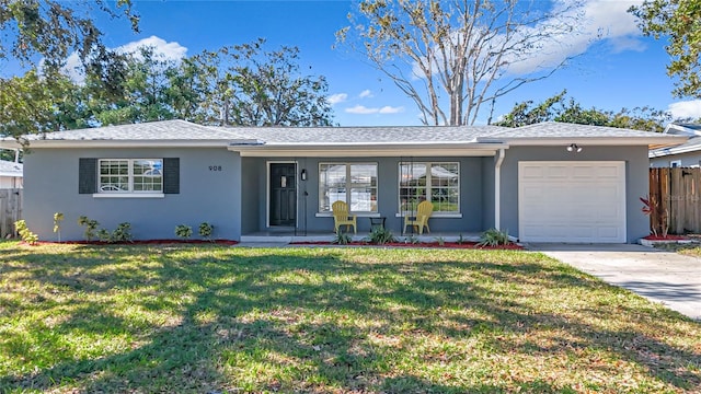 single story home featuring a front yard and a garage