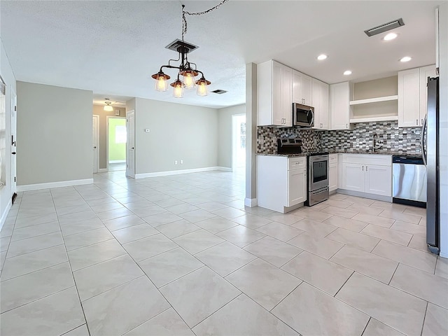 kitchen with backsplash, an inviting chandelier, sink, white cabinetry, and stainless steel appliances