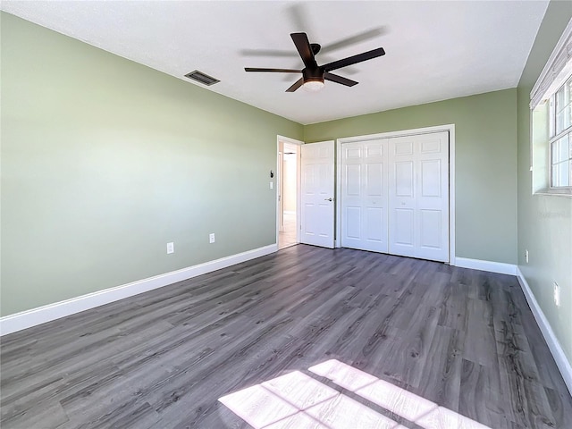 unfurnished bedroom featuring ceiling fan, wood-type flooring, and a closet