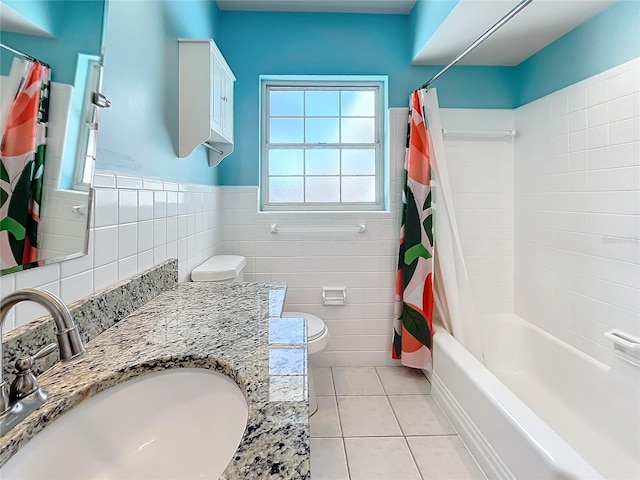 full bathroom featuring shower / bathtub combination with curtain, tile patterned flooring, toilet, vanity, and tile walls