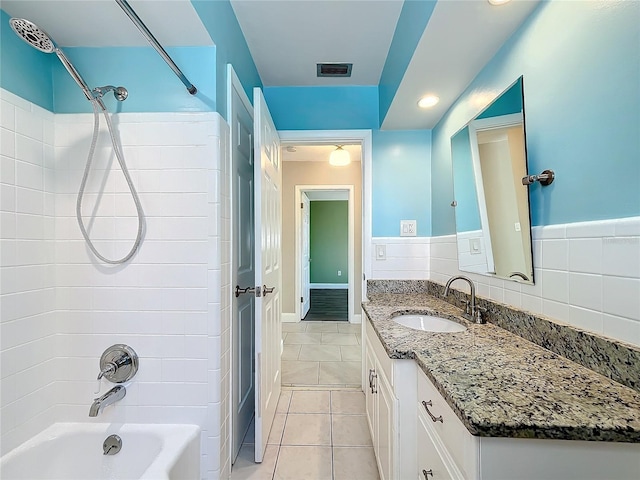 bathroom featuring tile patterned flooring, vanity, and shower / bathtub combination