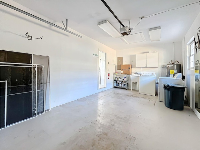 garage with electric water heater, a garage door opener, and washer / dryer