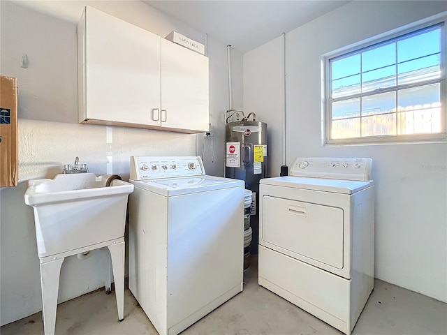 clothes washing area with washer and dryer, cabinets, electric water heater, and sink