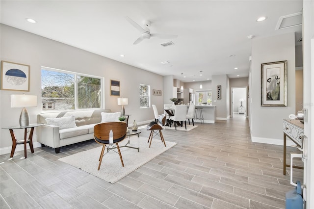 living room featuring ceiling fan and light wood-type flooring