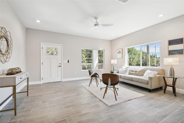 living room with ceiling fan and light hardwood / wood-style floors