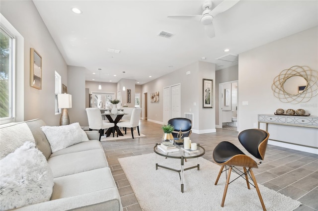 living room featuring ceiling fan and wood-type flooring