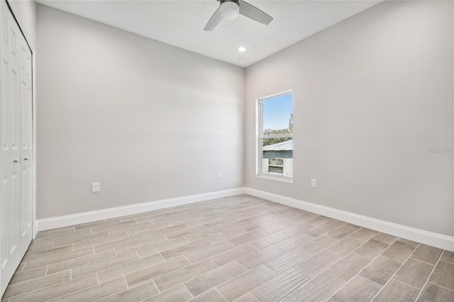 empty room with ceiling fan and light wood-type flooring