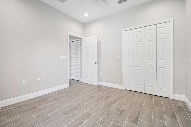 unfurnished bedroom featuring a closet and light hardwood / wood-style floors