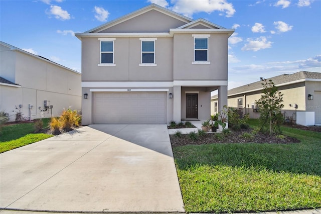 view of property featuring a garage and a front yard