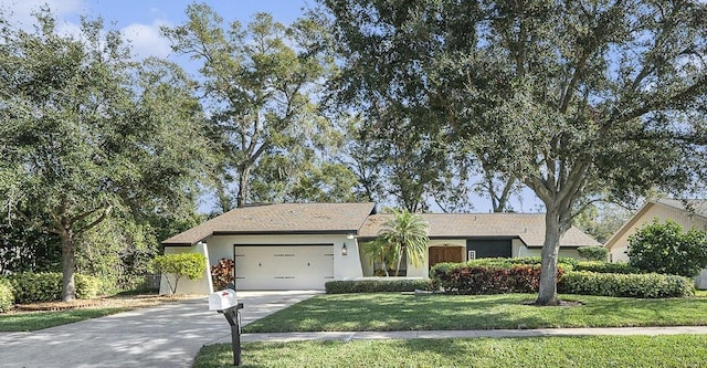 ranch-style house featuring a front yard and a garage